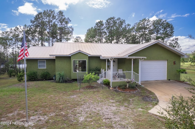 single story home with a front lawn, a garage, and covered porch