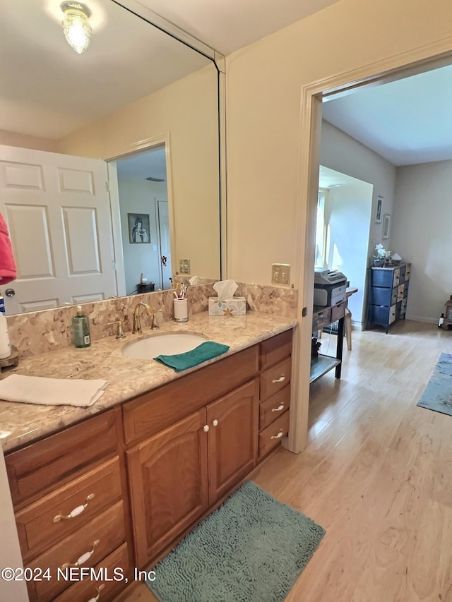 bathroom featuring hardwood / wood-style floors and vanity