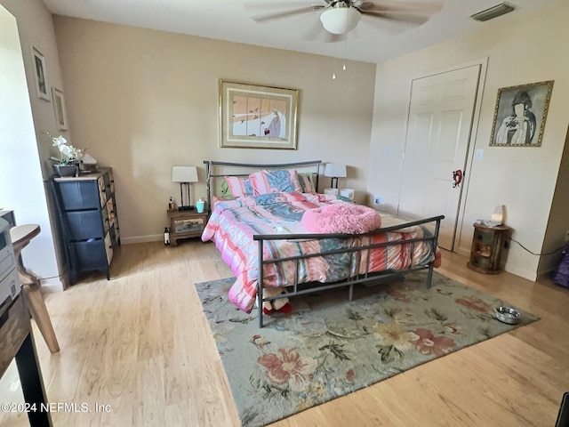 bedroom with light hardwood / wood-style floors and ceiling fan