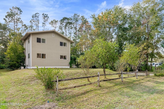 view of property exterior featuring a lawn