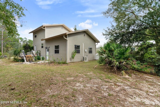 rear view of house with a lawn