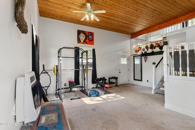 exercise area with wooden ceiling, heating unit, carpet, and ceiling fan