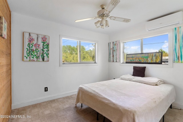 bedroom with an AC wall unit, light carpet, and ceiling fan