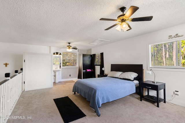 carpeted bedroom with ceiling fan and a textured ceiling