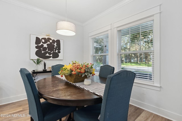 dining room with ornamental molding and wood-type flooring