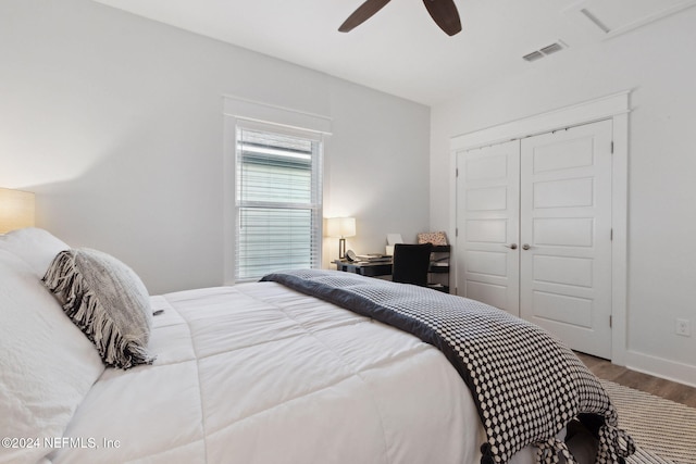 bedroom featuring hardwood / wood-style floors, a closet, and ceiling fan