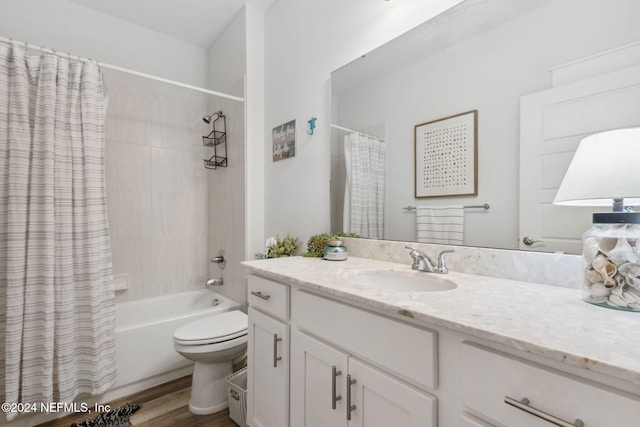 full bathroom with vanity, toilet, wood-type flooring, and shower / bath combo with shower curtain