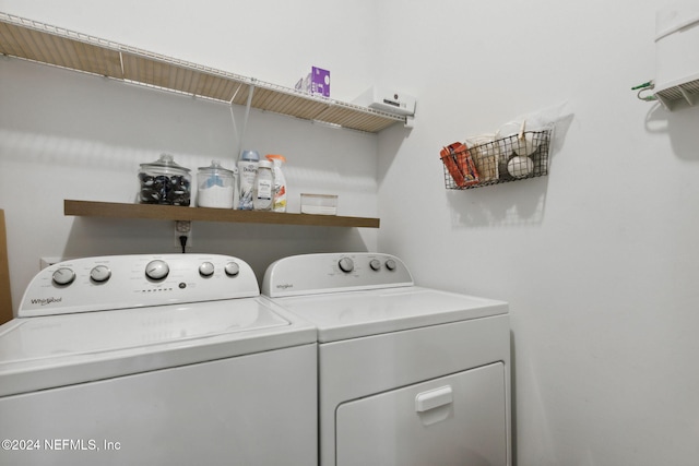 clothes washing area with washing machine and clothes dryer