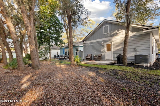 rear view of house with a patio area and central AC unit