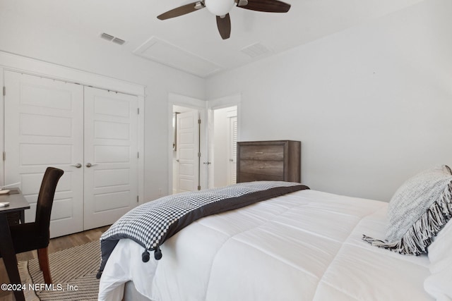 bedroom with a closet, hardwood / wood-style flooring, and ceiling fan