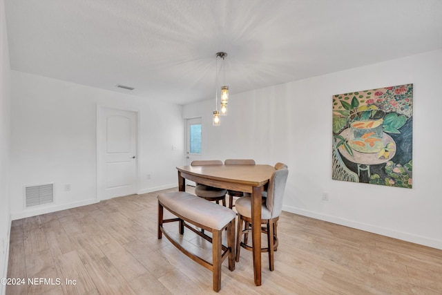 dining area featuring light wood-type flooring