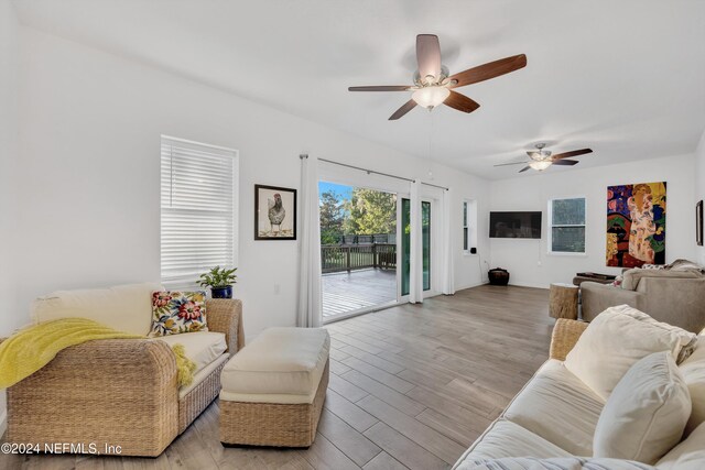 living room featuring light hardwood / wood-style floors and ceiling fan