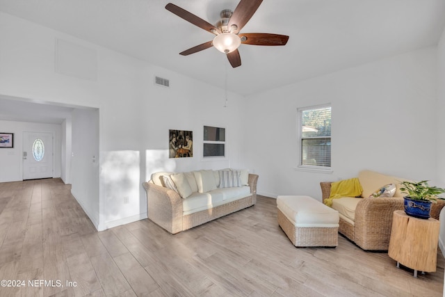 living room with light hardwood / wood-style floors and ceiling fan