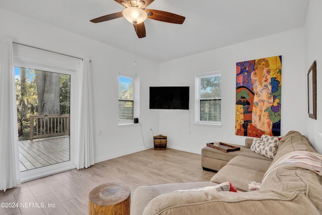 living room with light wood-type flooring and ceiling fan