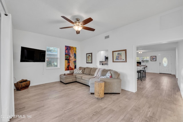 living room with ceiling fan and light wood-type flooring