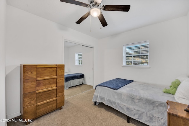 bedroom with light carpet, a closet, and ceiling fan