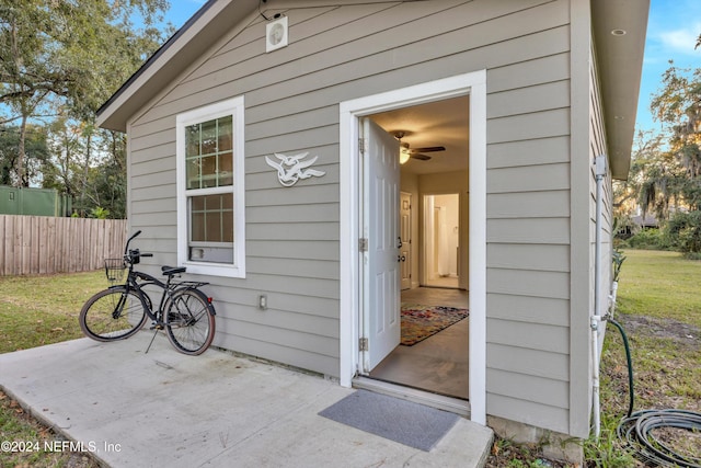 property entrance featuring a patio and a lawn