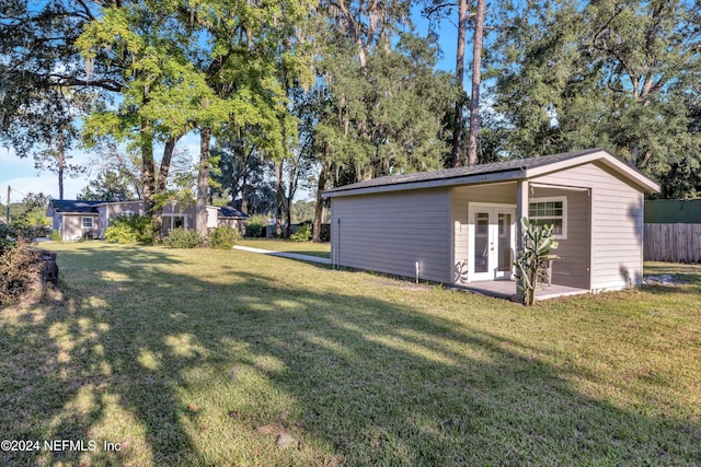 view of yard featuring french doors and an outbuilding