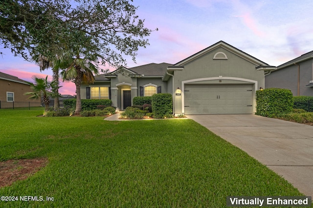 ranch-style house with a lawn and a garage