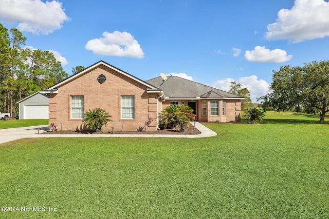 ranch-style home featuring a front lawn and a garage