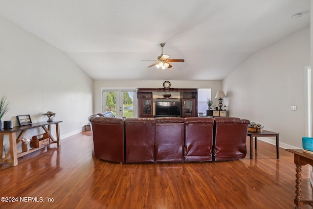 living room featuring ceiling fan, hardwood / wood-style flooring, and vaulted ceiling