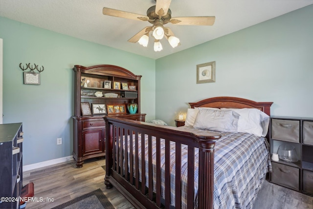 bedroom featuring ceiling fan and hardwood / wood-style flooring