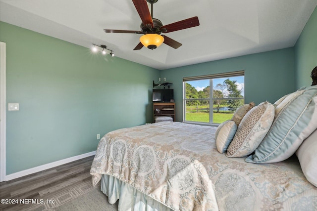 bedroom with ceiling fan and dark hardwood / wood-style flooring