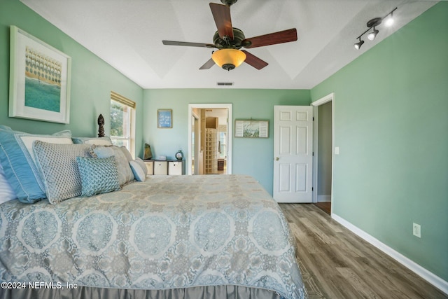 bedroom with ceiling fan, wood-type flooring, and ensuite bath