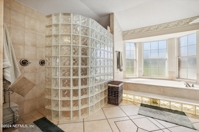 bathroom with shower with separate bathtub, a textured ceiling, and tile patterned flooring