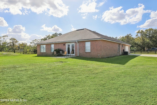 back of house featuring a patio and a lawn