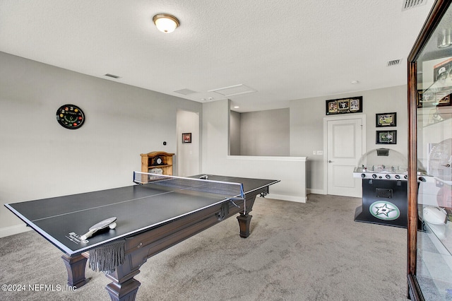 rec room with baseboards, carpet floors, visible vents, attic access, and a textured ceiling