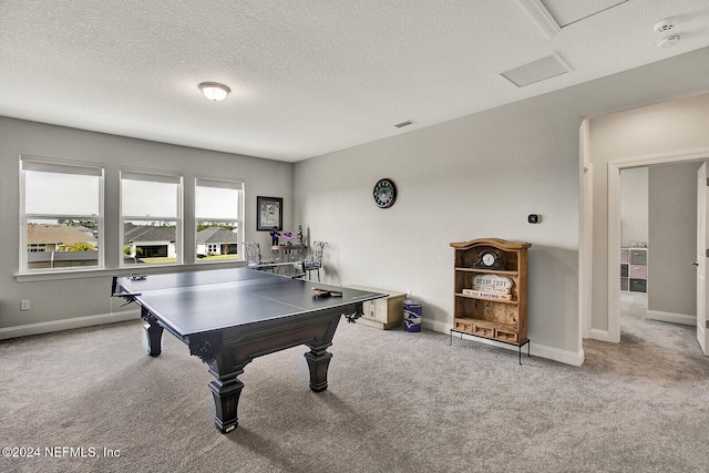 rec room featuring a textured ceiling and light colored carpet