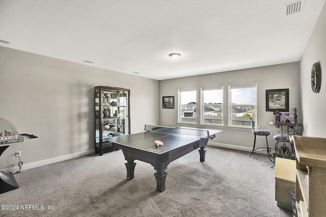 rec room featuring a textured ceiling, visible vents, light carpet, and baseboards