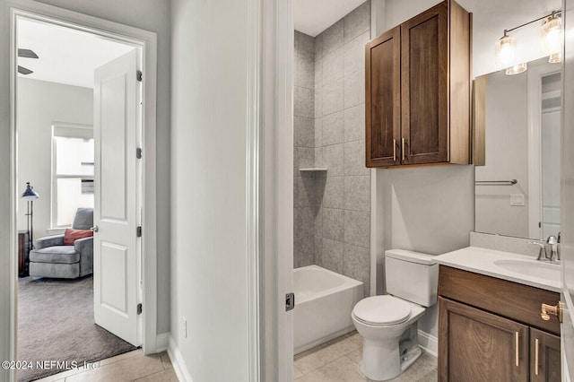 full bathroom featuring vanity, tiled shower / bath, toilet, and tile patterned floors