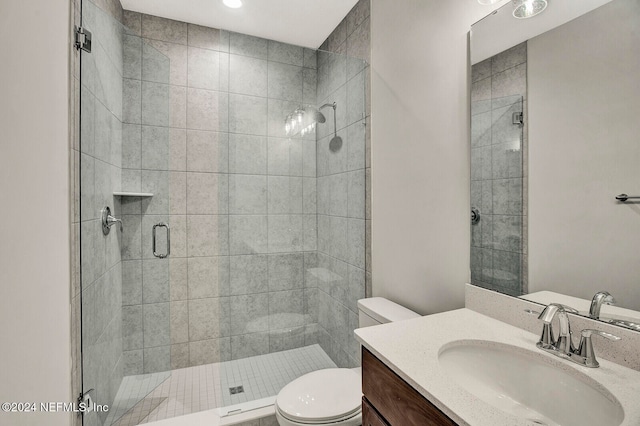 bathroom featuring vanity, toilet, and an enclosed shower