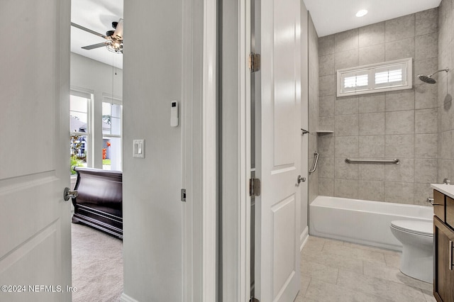 full bath with toilet, tile patterned floors, a ceiling fan, washtub / shower combination, and vanity