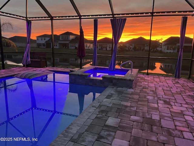 view of pool featuring a residential view, a patio, and a pool with connected hot tub