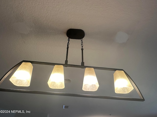 interior details with a textured ceiling