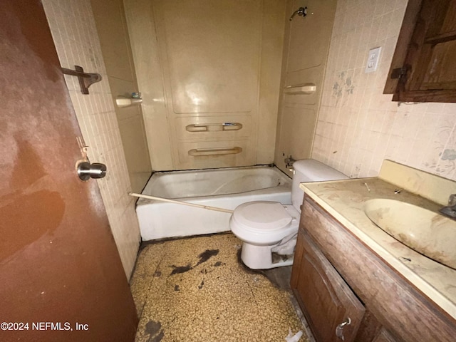 full bathroom with vanity, toilet, bathtub / shower combination, and tile walls