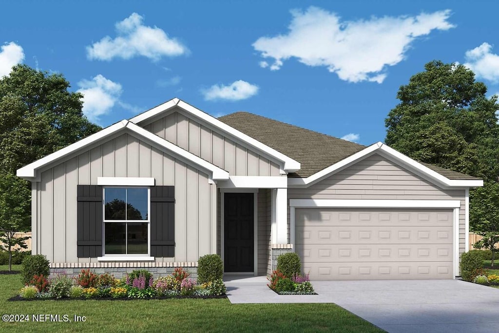 view of front of house with a front yard and a garage