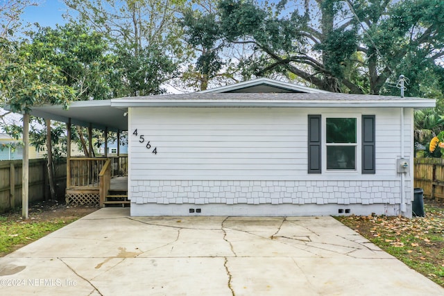 view of side of property featuring a patio