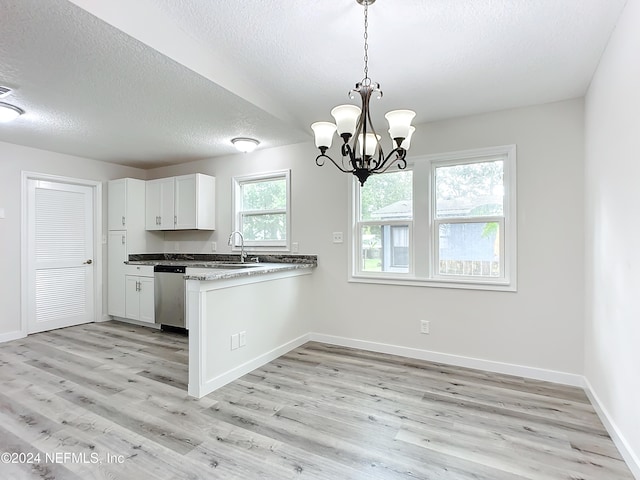 kitchen with dishwasher, kitchen peninsula, pendant lighting, white cabinetry, and light hardwood / wood-style floors