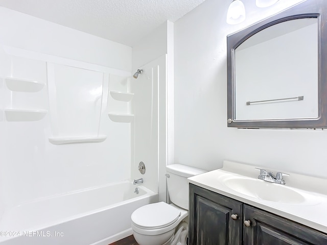 full bathroom with vanity, a textured ceiling, toilet, and tub / shower combination