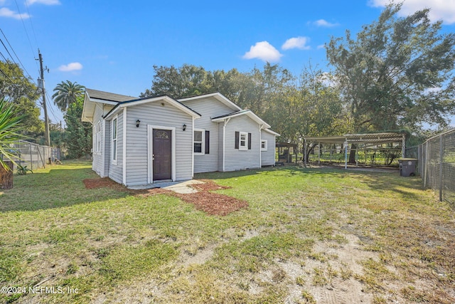 rear view of property with a yard