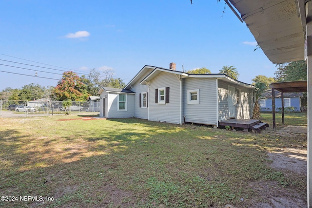 view of side of property with a lawn