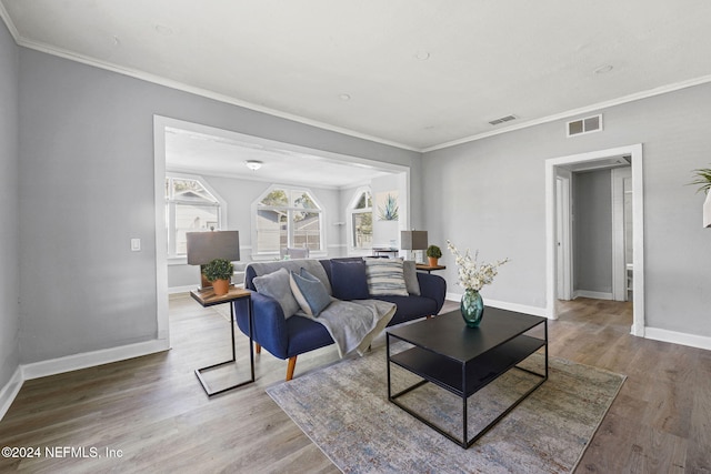 living room with crown molding and hardwood / wood-style flooring