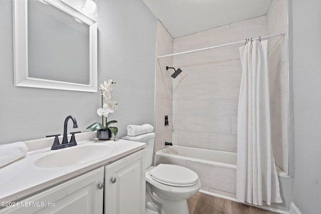 full bathroom with shower / tub combo, vanity, hardwood / wood-style flooring, and toilet