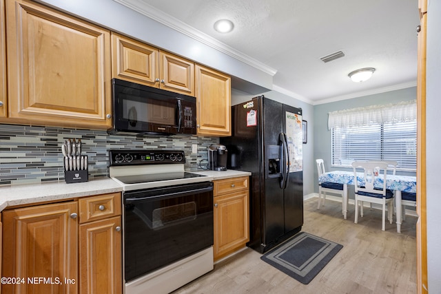 kitchen featuring backsplash, ornamental molding, black appliances, and light wood-type flooring