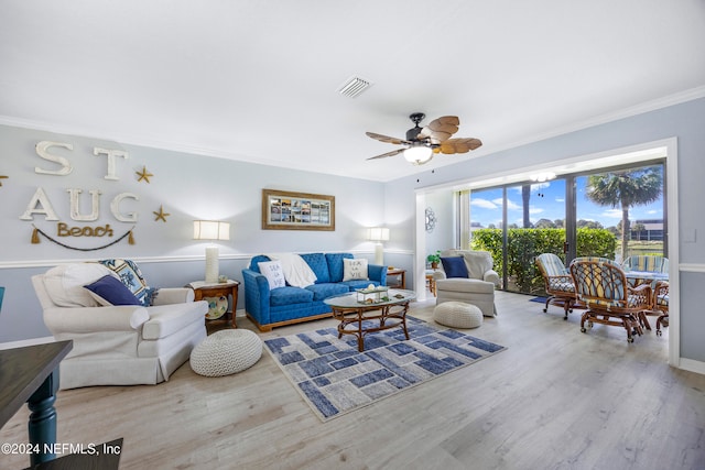 living room with hardwood / wood-style floors, ceiling fan, and ornamental molding