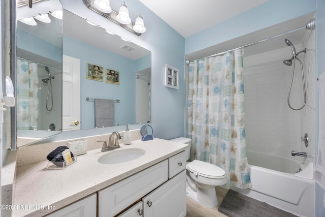 full bathroom featuring toilet, vanity, hardwood / wood-style flooring, and shower / tub combo with curtain